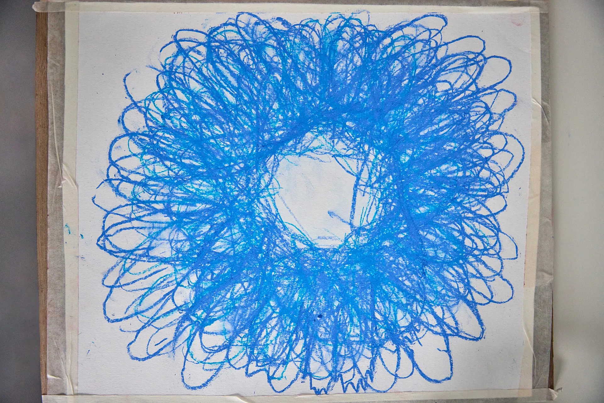 Das quadratische Kunstwerk zeigt eine blumenartige Figur, die aus den Umrissen der Hände von vielen Menschen entstanden ist.