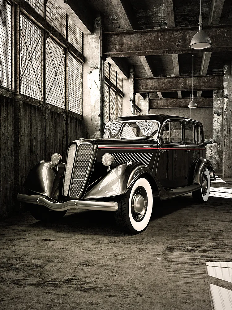 Schwarzer Oldtimer mit weißen Reifen steht in einer industriellen Garage neben roten Fässern.