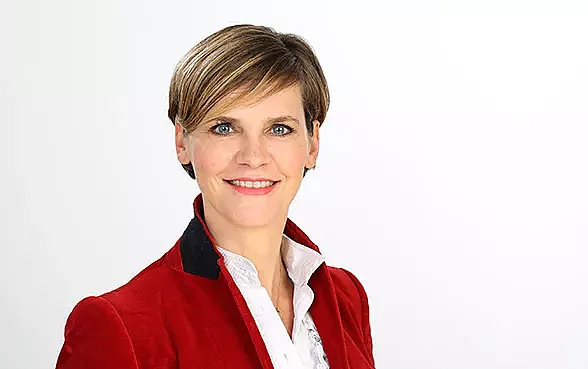 Franka Barsch, Head of Claims Europe, trägt einen roten Blazer und lächelt in die Kamera.