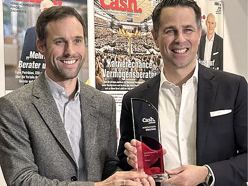 Franz Kupfer, Product Head Professional Indemnity, D&O, Property & Event und Tim Bethge, Geschäftsführer von Hiscox Deutschland halten den Cash Innovations Award für die neuen Hiscox Arbeitsausfall-Versicherung in der Hand. Beide lächeln sympathisch in die Kamera.